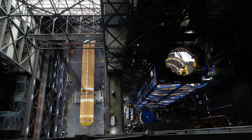 Overhead view of the SLS core stage standing through the center of the Vehicle Assembly Building