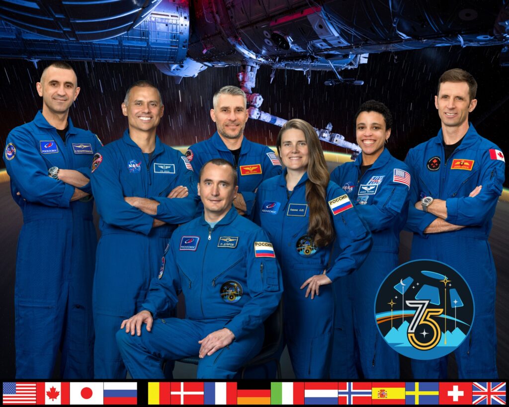 Official portrait of the seven-member Expedition 75 crew: Teteryatnikov, Menon, Dubrov, Delaney, Kikina, Watkins and Kutryk.