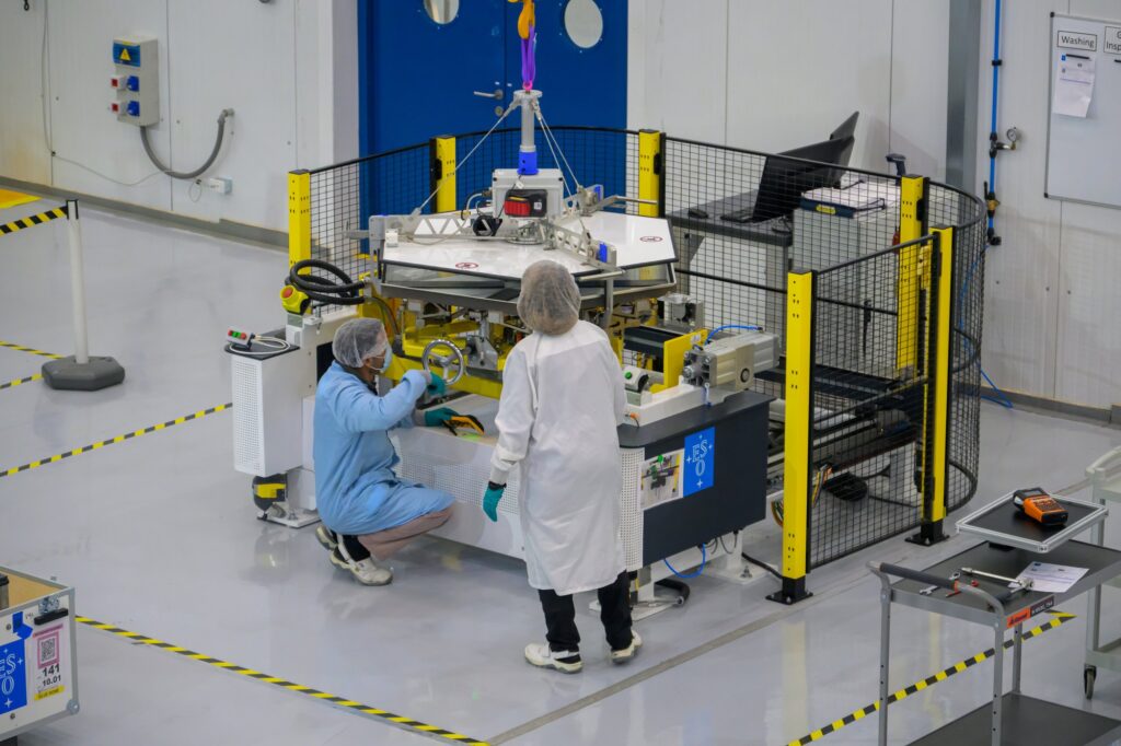 Technicians at the ELT Technical Facility oversee a coating stage for an ELT mirror segment