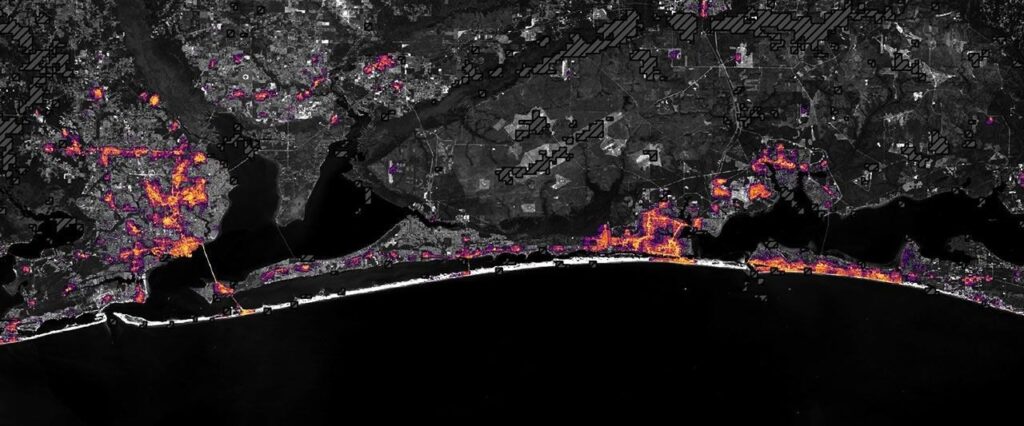 The same area on October 12, 2026, with lights in Pensacola and Destin and along the road between them closer to pre-storm levels.