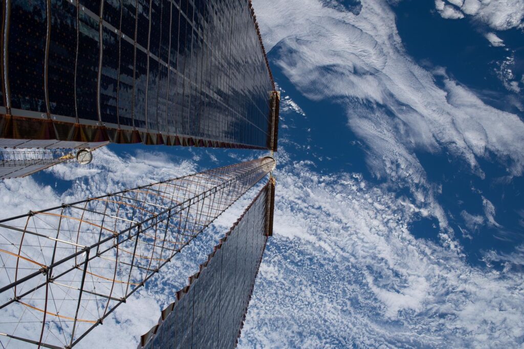 A view down a pair of the International Space Station's roll-out solar arrays, from a March 2026 spacewalk