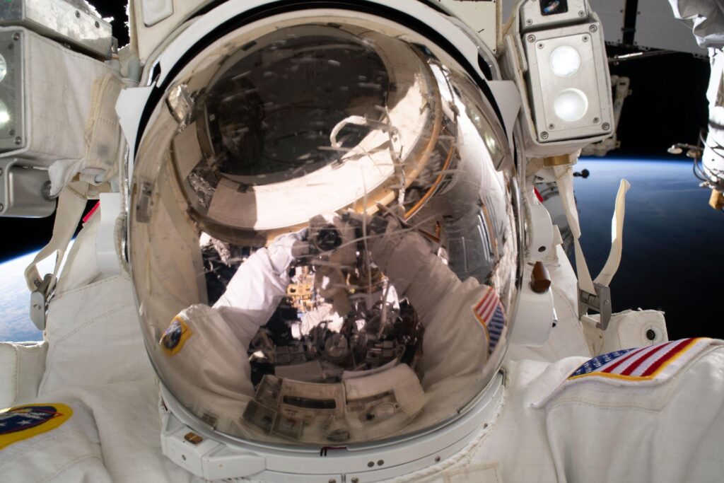 Astronaut Woody Hoburg taking a selfie during a June 2023 spacewalk to install a roll-out solar array