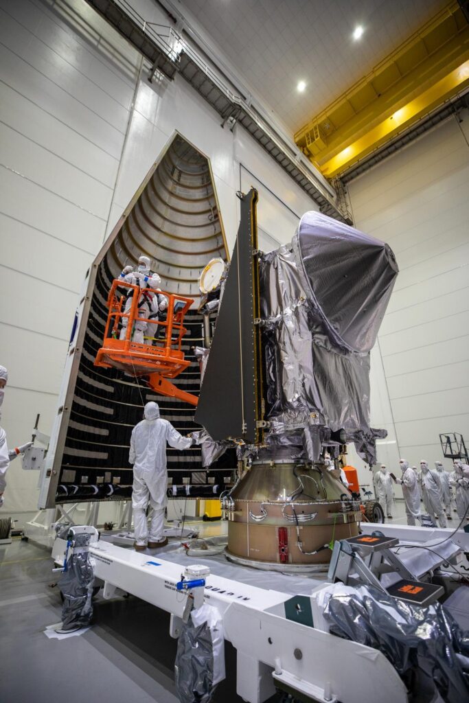 Workers move half of the payload fairing toward NASA's Lucy spacecraft at Astrotech in Titusville, Florida, on Sept. 30, 2021