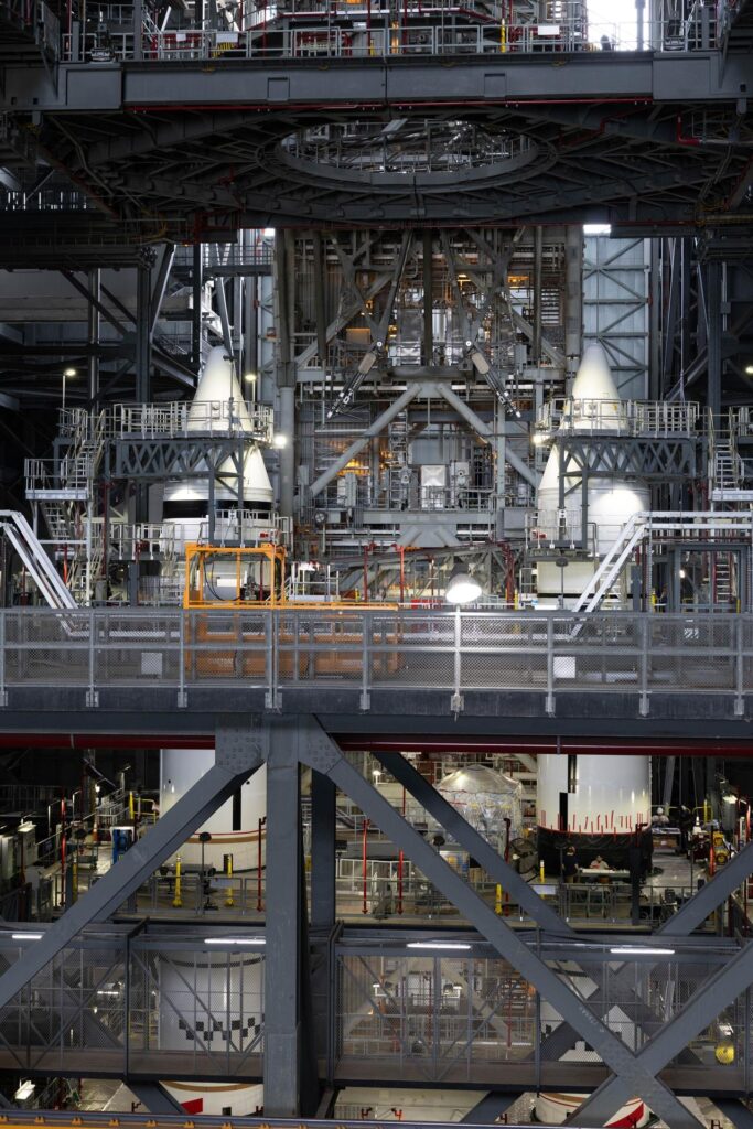 Solid rocket booster segments with nose cone hardware inside the Vehicle Assembly Building at Kennedy Space Center