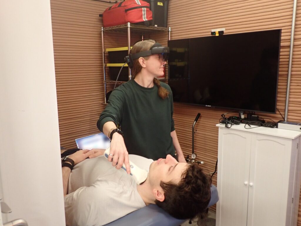Medical officer Ellen Ellis performing a medical task with commander Ross Elder