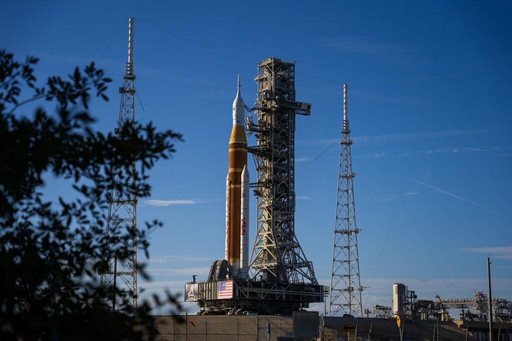 The SLS rocket and Orion leaving the Vehicle Assembly Building on the crawler-transporter for Launch Pad 39B ahead of Artemis II