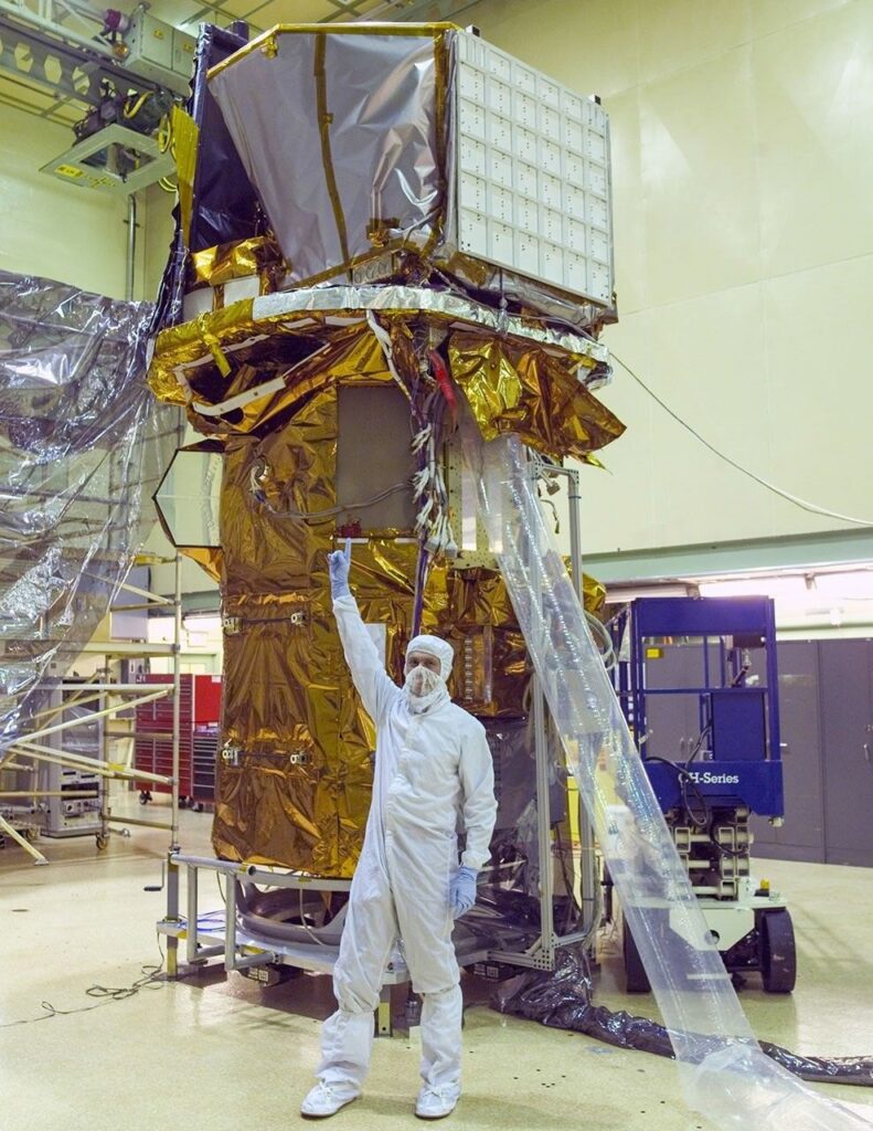 Neil Gehrels, Swift's first principal investigator, points to the instruments on the completed Swift spacecraft in a clean room at NASA Goddard on Sept. 9, 2003