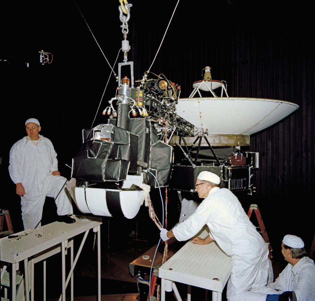 One of the Voyager spacecraft inside the 25-Foot Space Simulator thermal vacuum chamber at JPL, April 27, 1977