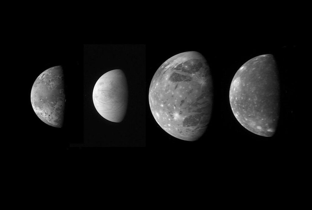 Jupiter's four large Galilean moons shown as partly lit disks